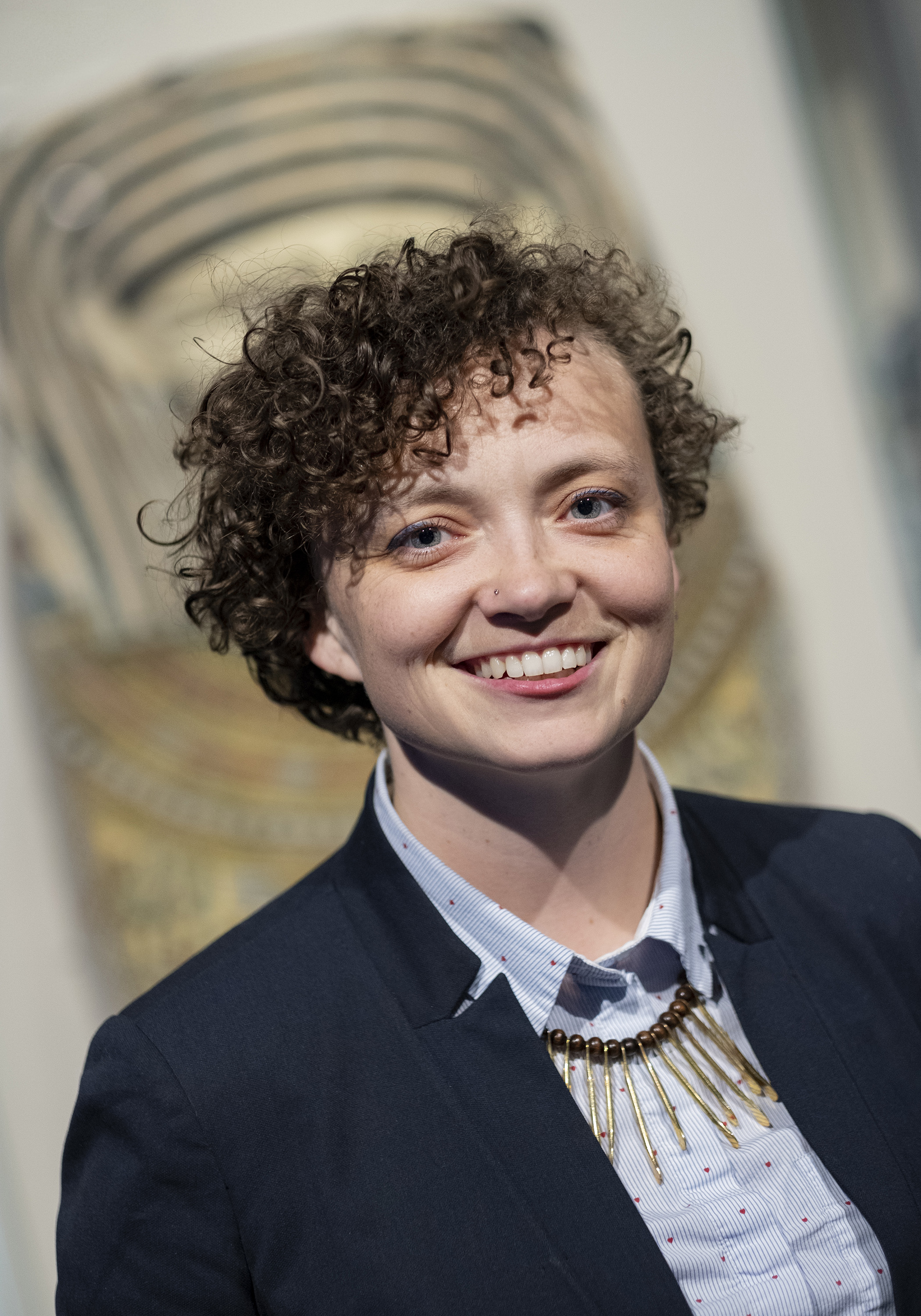 photo of a smiling person with curly hair