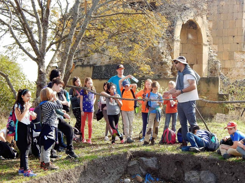 David Berikashvili of the University of Georgia and QSI students at the archaeological site of Samshvilde