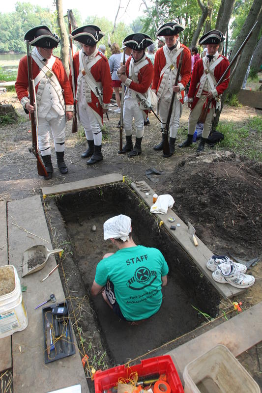British soldiers look down on French archaeological deposits at Fort St. Joseph.