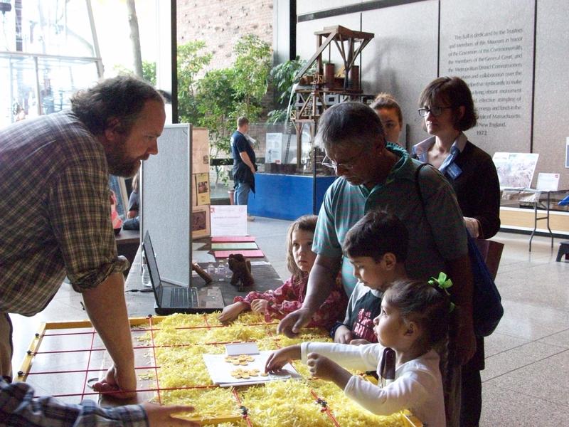 Presenters from MA Board of Underwater Archaeological Resources help fair attendees excavate an underwater site.