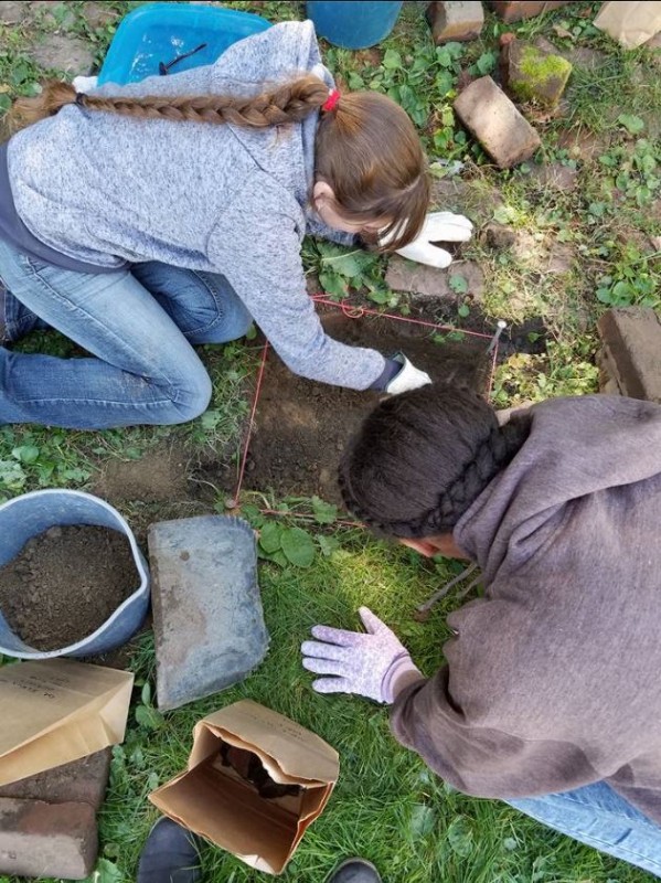 Two of the participants digging in the water cistern of the Elkins House property. (Photo Courtesy of Paul Stewart)