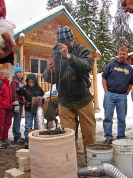Professor of Education at MSU and Montana State University metalsmith Bryan Peterson removes a crucible from the forge.