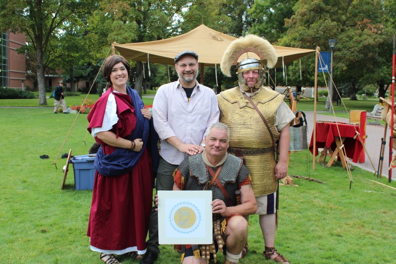 Dr. David Oosterhuis (center), president of the AIA-Spokane Society, with Adrienne Carson (L), David Hames (R), and Jim Franklin, at front with the society logo (photo by A. Goldman).