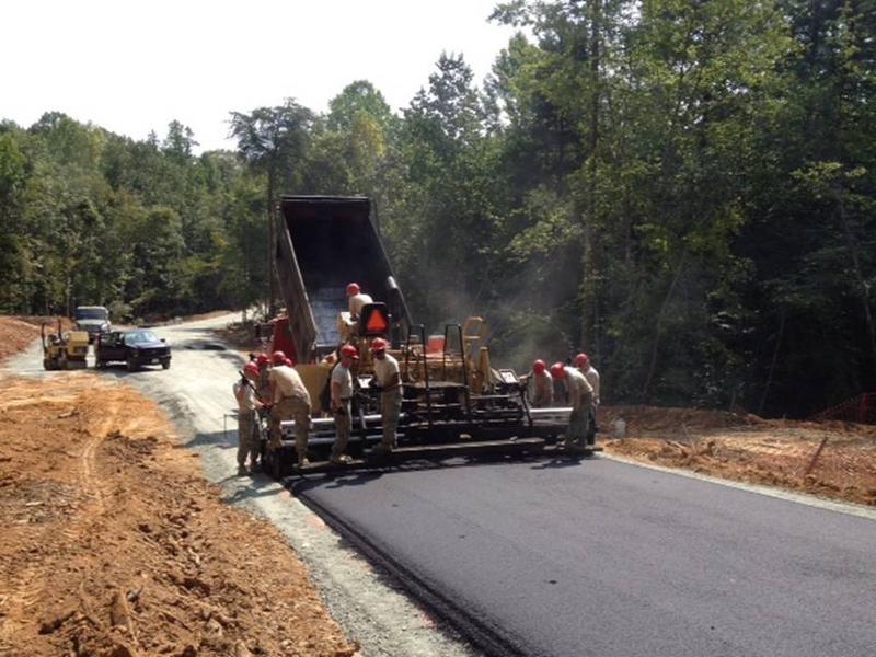 Military personnel work on the construction of a park road