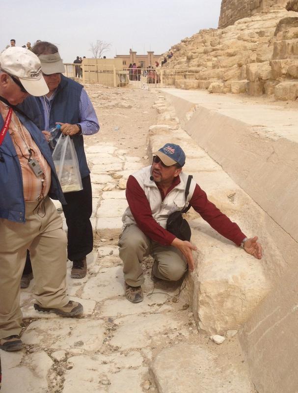Our AIA group’s Egyptian guide, Mahmoud, describes how casing blocks were smoothed on the exterior of a queen's pyramid, Giza Image credit: Stephen Harvey