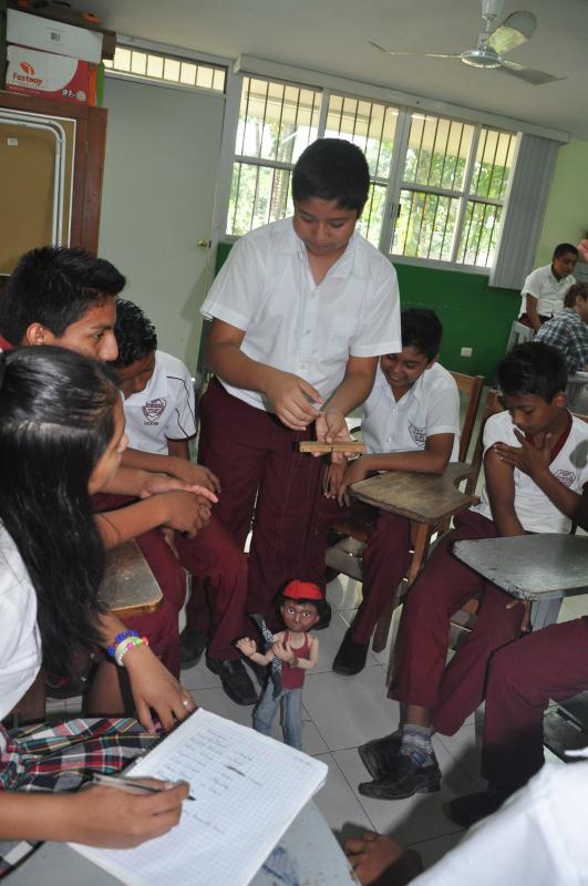 Secondary students in Tahcabo get comfortable operating the marionettes.