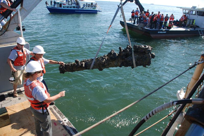 Team members recovering  a cannon from the shipwreck.