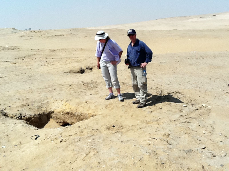 AIA Members Dr. Sarah Parcak of the University Alabama at Brimingham and Dr. Eric Cline of The George Washington University inspecting a looter's pit outside of Abusir.