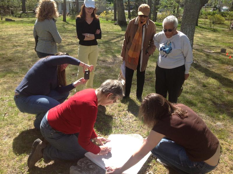 Volunteers try a hand at grave rubbing at the cemetery's Stewardship Spring Cleaning Day (Photo: AIA/ECHS)