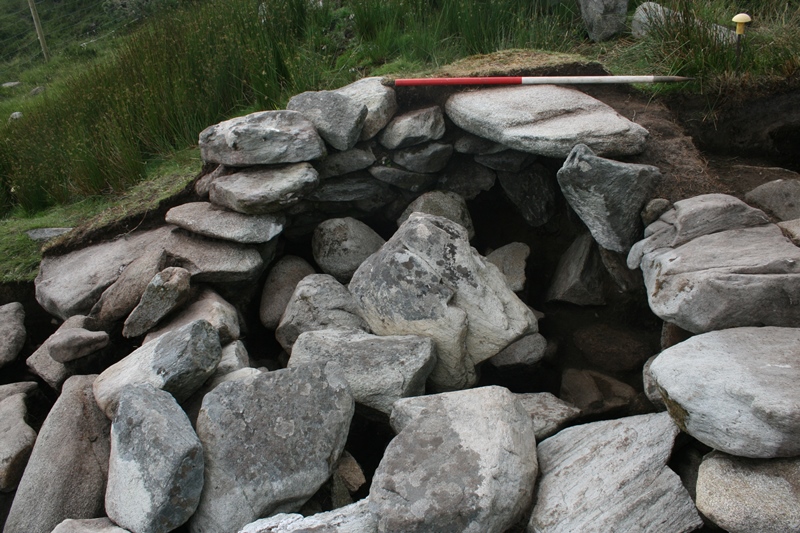 The better surviving western end of the small stone hut, filled with rubble