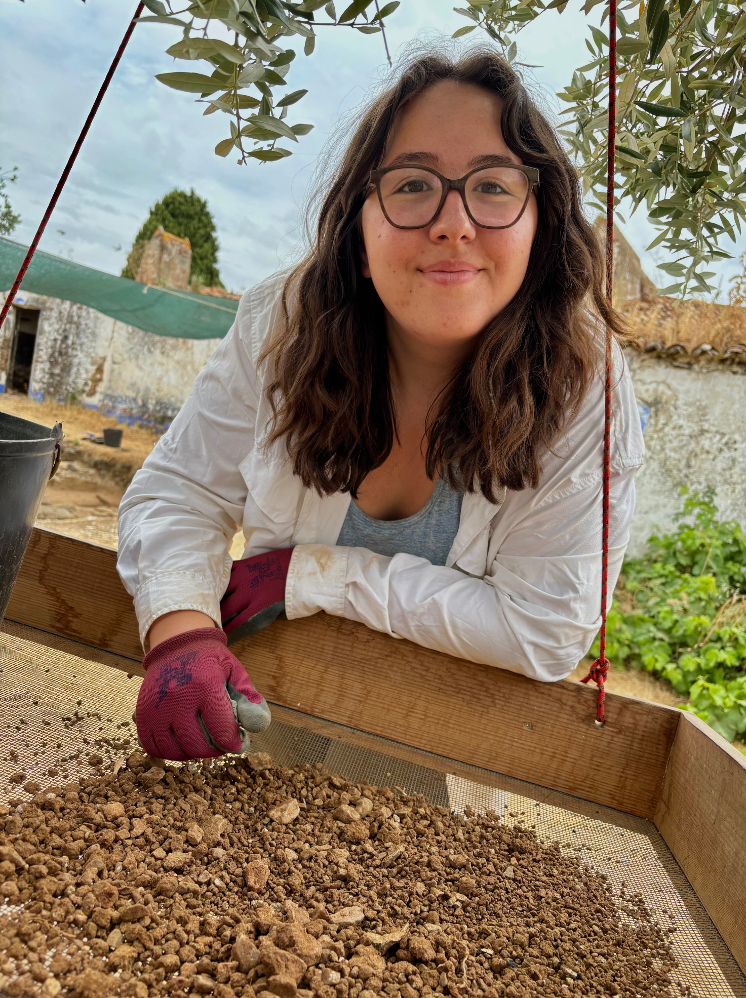 Redondo, Portugal, Emma Magnus sifting dirt for finds.