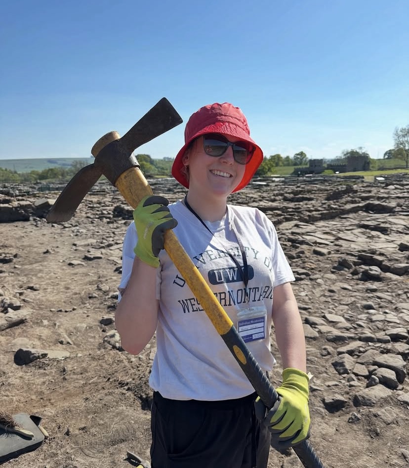  Vindolanda, England, Angela Weiler holding a mattock after a session of removing topsoil.
