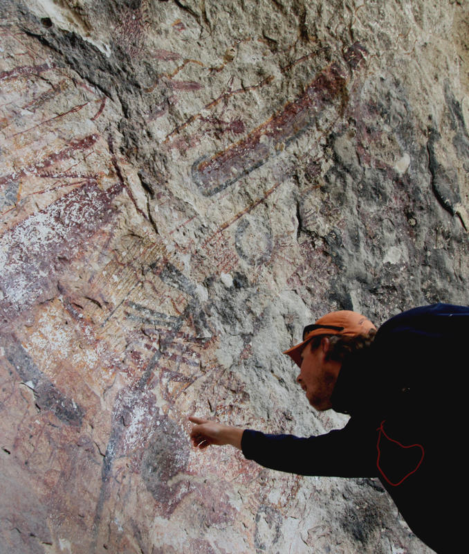 Figure 2. A SHUMLA research intern examines 4,000 year old Pecos River Style rock art at Panther Cave in the heart of the Lower Pecos Canyonlands. © 2011 SHUMLA